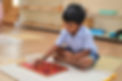 boy performing activity in Montessori class of sri gurukulam