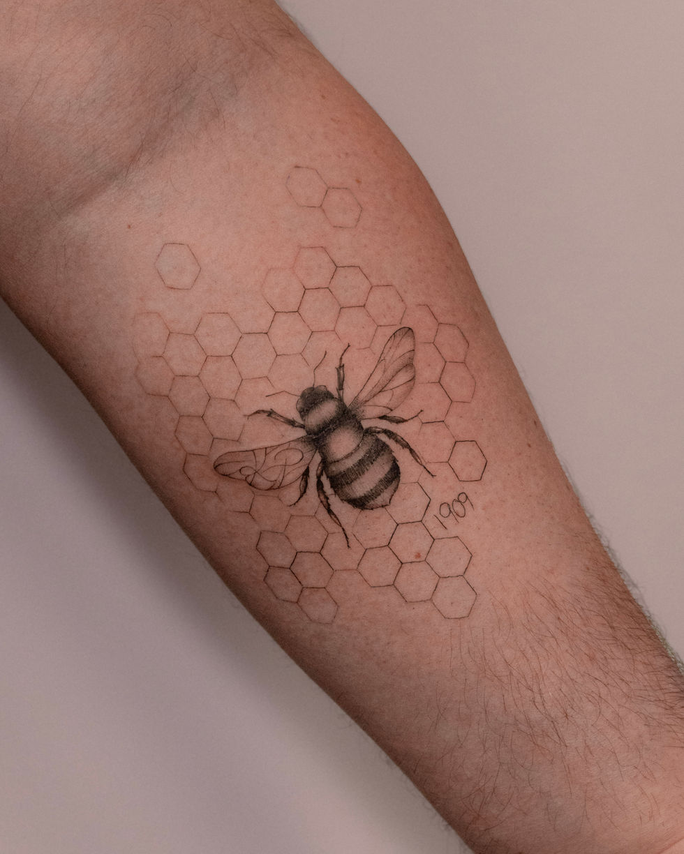 Micro realistic bee tattoo