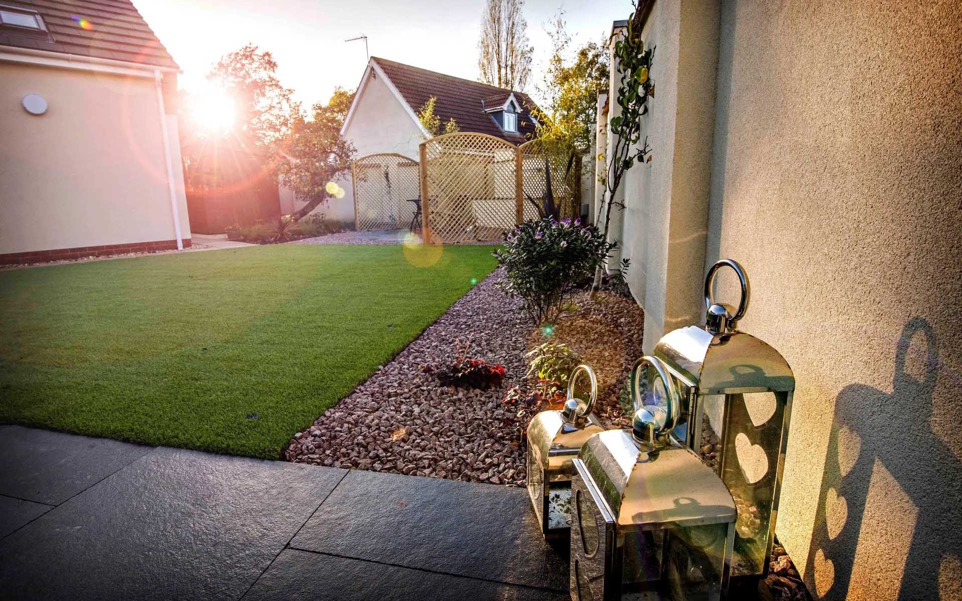 Garden lanterns next to newly laid lawn