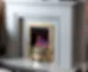 The Montana gas fire with gold trim and white fireplace surround