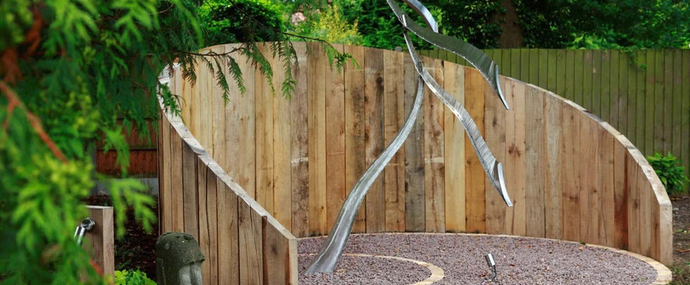 garden sculpture with coniferous trees in foreground