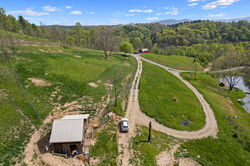 Aerial shot of French Broad River Farms. Shows farm roads with spacious green grass in between with 