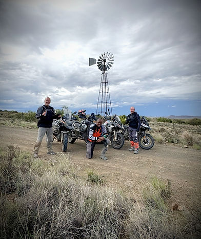 Riders on an adventure motorcycle tour in South Africa exploring remote gravel roads and mountain passes with Motorrad Adventures