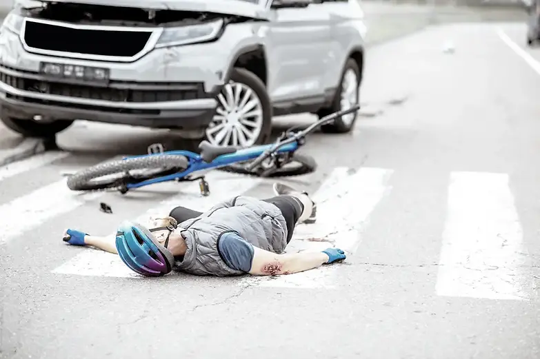 Bicyclist hit by SUV in pedestrian crosswalk – injured cyclist wearing helmet lying on road beside damaged bike after accident in Georgia