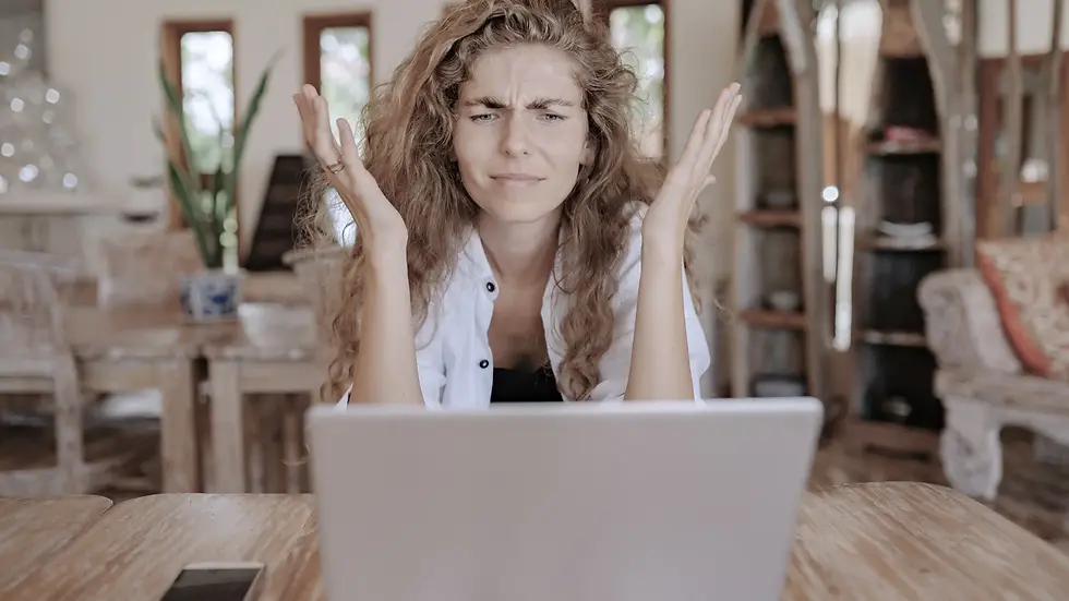 Woman with a laptop showing frustrations on her face after being denied ssdi benefits.