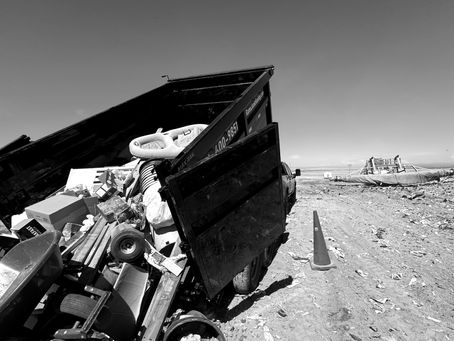 A dump trailer at the landfill off loading junk