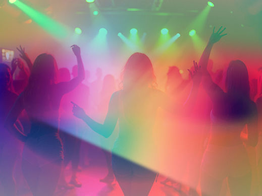 A vibrant-nightclub-scene-filled-with-dancing-LGBTQ+-women-under-colorful-lights-with-an-a