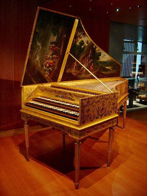 An ornate harpsichord with intricate floral designs and painted lid in a dimly lit room, wooden floor enhancing its antique charm.