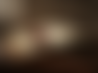 A single red rose rests upon an open music book, accompanied by an old quill and spectacles, creating a scene of timeless elegance and artistic inspiration.