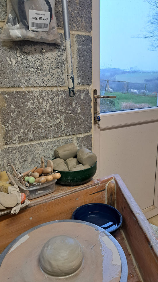 Clay centered on a pottery wheel in a studio