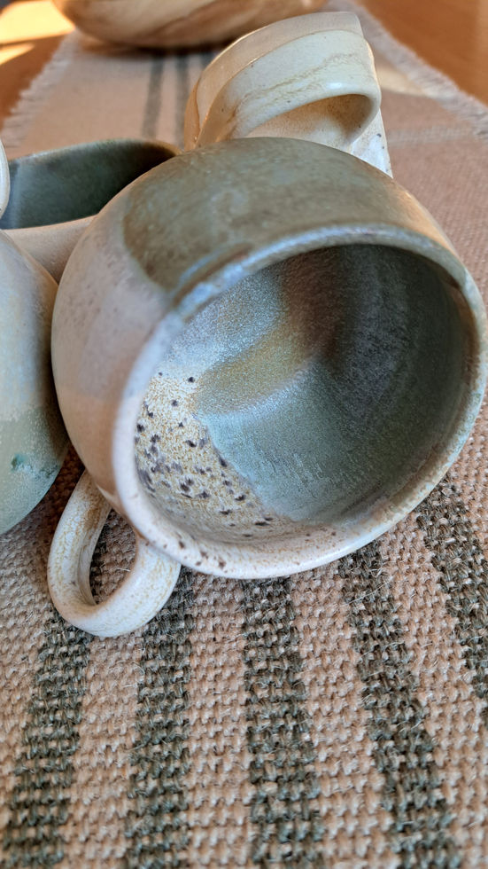 Handmade ceramic cups with a layered sky blue, grey and speckled natural white glaze pattern; wheel-thrown in Catton, Northumberland 