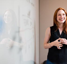 Female software engineer in meeting by whiteboard_edited.jpg