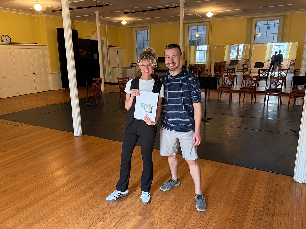 Peter Fenton and Amanda Cutalo in rehearsal for In Theater and War, posing together and smiling in a rehearsal room