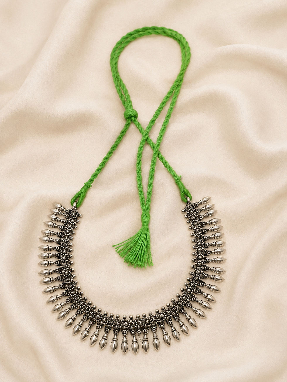 Athizay green thread oxidised silver necklace featuring intricate traditional detailing and elegant teardrop charms.