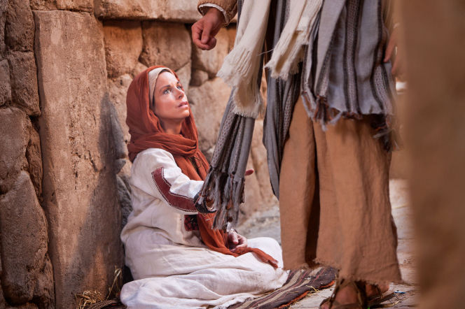 A woman with an issue of blood touches the clothes of Jesus..jpg