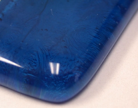 American Made Lightstreams Glass Tile, a photograph of a piece of glass tile corner bullnose trim piece used for pool tile, spa tile, kitchen tile, shower tile, bathroom tile, backsplash tile, floor tile, waterline tile, and step marker tile