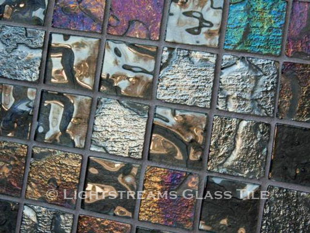 High quality American made Lightstreams Gold Iridescent Collection Silverado glasstiles are a beautiful silver / grey (gray) color on the shiny side of the tile, with metallic iridescent colors on the reverse side. American made Lightstreams Glass Tile is used for pool tile, spa tile, waterline tile, step marker tile, accent tile, wall tile, fountain tile, floor tile, bathroom tile, shower tile, kitchen tile, and kitchen backsplash tile.