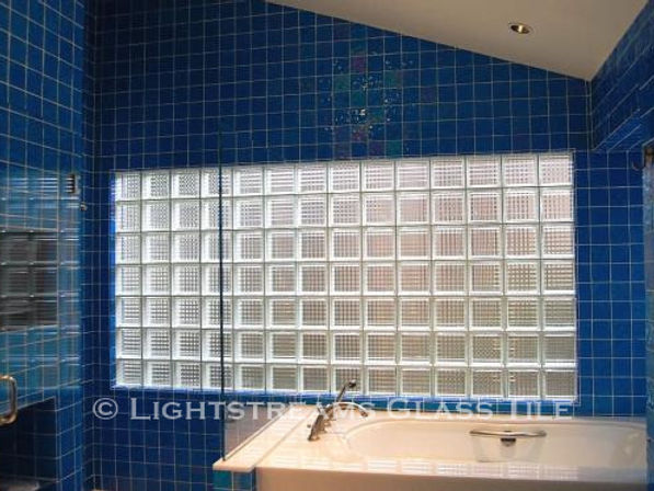 American Made Lightstreams Glass Tile Turquoise is used as bathroom tile, shower tile, and wall tile for this all tile bathroom. This bathroom mostly displays the shiny smooth side of Lightstreams iridescent / shiny reversible blue tile.