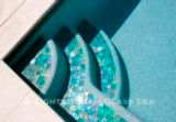 American made Lightstreams Glass Tile Renaissance Colletion Celadon green pool tile on the pool waterline and pool steps as step markers
