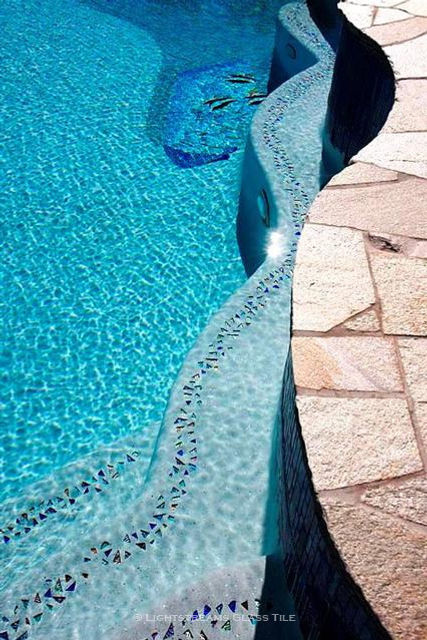 American Made Lightstreams Glass Tile, Two parallel strands of Shell Beach glass accent tile strands edge the wavy edge of this light plastered pool steps, creating double the whimsical feel of the Shell Beach glass. Also can be used as accent pool tile, spa tile, wall tile, floor tile, waterline tile, step tile, step marker tile, fountain tile, spillway tile, interior tile, and exterior tile.