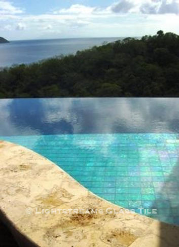 American Made Lightstreams Glass Tile Renaissance Colllection Aqua Blue tile is used as pool tile and spa tile for this outdoor / indoor pool and spa at this luxury St. Lucia Resort. Only the iridescent tile side is shown face up in this all tile pool and all tile spa