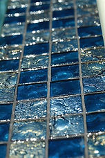 American made Lightstreams Glass Tile is used for pool tile, spa tile, waterline tile, step marker tile, accent tile, wall tile, fountain tile, floor tile, bathroom tile, shower tile, kitchen tile, and kitchen backsplash tile. This swimming pool and spa is done is Lightstreams Gold Iridescent Collection Steel Blue in 2x2 tile size.
