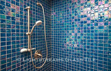American made Lightstreams Glass Tile is used for pool tile, spa tile, waterline tile, step marker tile, accent tile, wall tile, fountain tile, floor tile, bathroom tile, shower tile, kitchen tile, and kitchen backsplash tile. This shower has Lightstreams Renissance Collection Peacock on the shower walls and floor