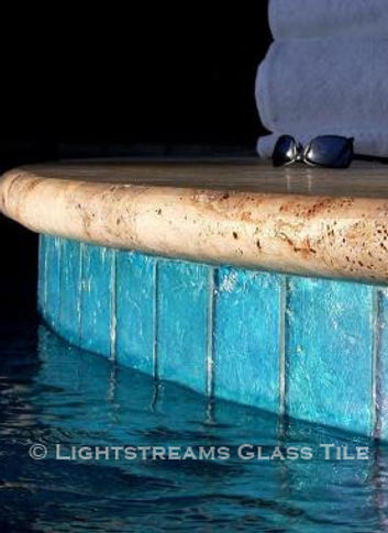 American Made Lightstreams Glass Tile Renaissance Colllection Aqua Blue tile is used as pool tile and spa tile for this outdoor / indoor pool and spa at this luxury St. Lucia Resort. Only the iridescent tile side is shown face up in this waterline tile photo of this all tile pool and all tile spa