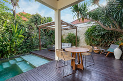 Villa Madu poolside outdoor dining area with tropical garden, Seminyak Bali