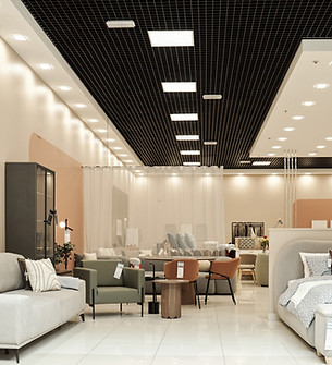 Modern furniture store interior displaying contemporary sofas, armchairs, tables, and bed