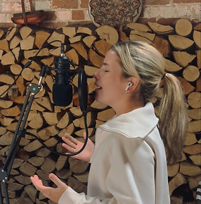 Side profile of Mia Garner delivering a soulful performance in a recording studio
