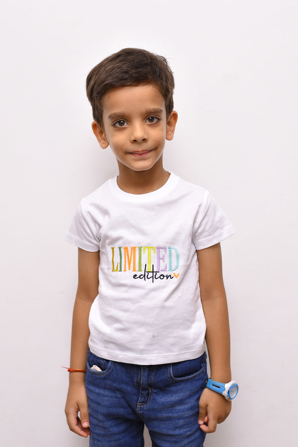 Thumbnail: another photo of a boy wearing a t shirt by Hugs&Hues having "Limited Edition" embroidered on it in colourful threads and posing