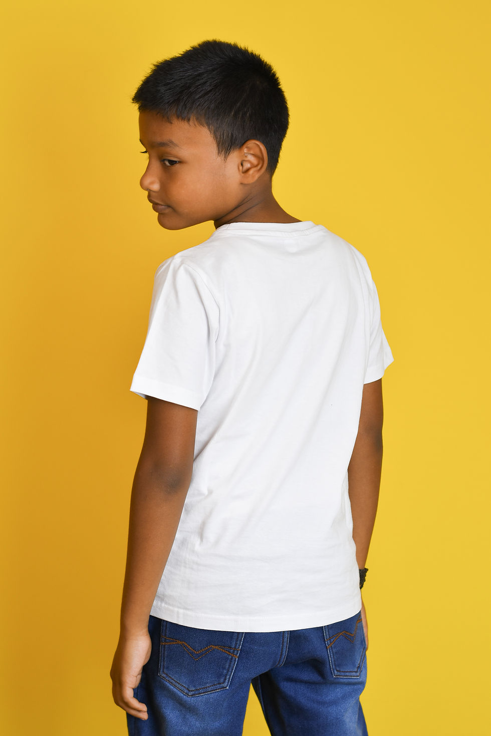 Thumbnail: a back view photo of a boy wearing a t shirt by hugs&hues having a running sonic embroidered on it