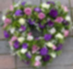 Funeral heart tribute with mixed foilage and pink, white and purple flowers