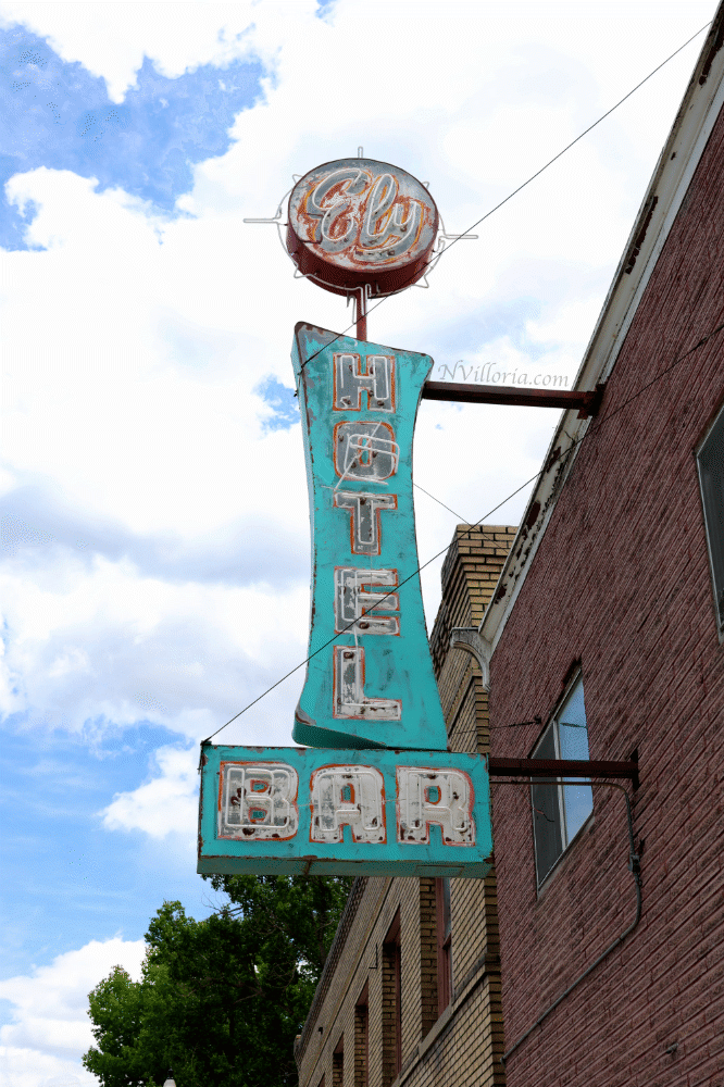 A teal, dated, neon sign on the exterior of a brick building in Ely, Nevada - via NVilloria.com