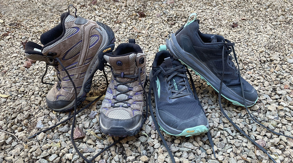 Merrell Moab and Altra Lone Peak shoes side by side on rocks