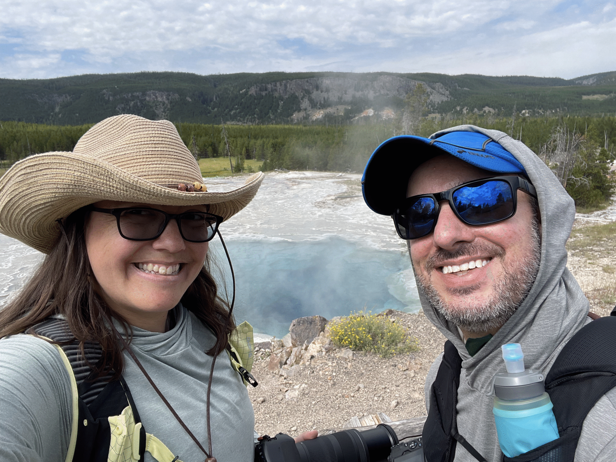 Nikki and Jason in front of a geyser pool at Yellowstone National Park - via NVilloria.com