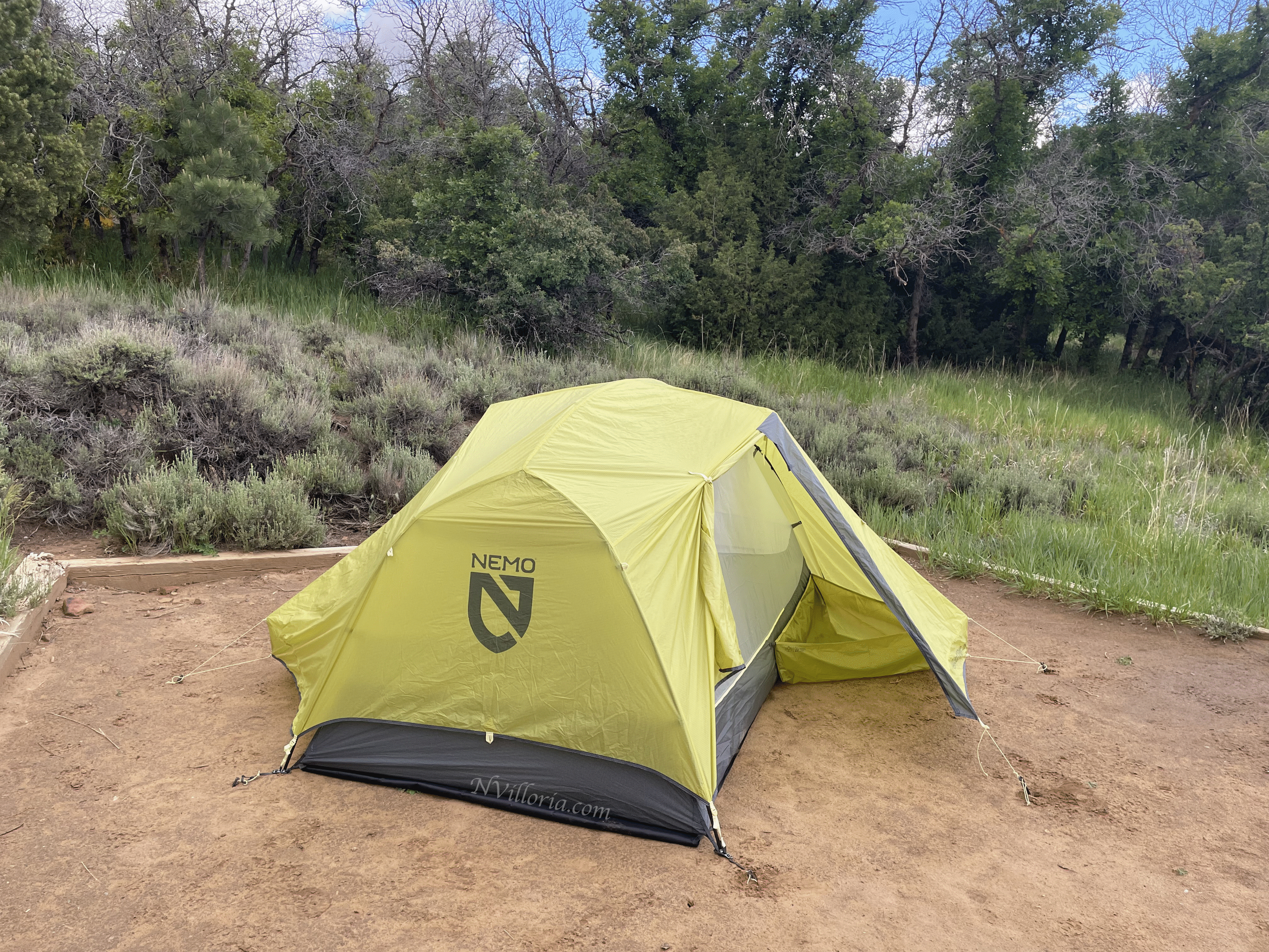 A green tent set up in a campground via NVilloria.com
