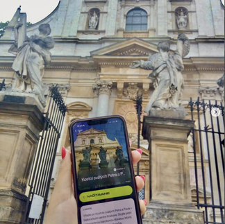 detail of a mobile screen in front of a historical building