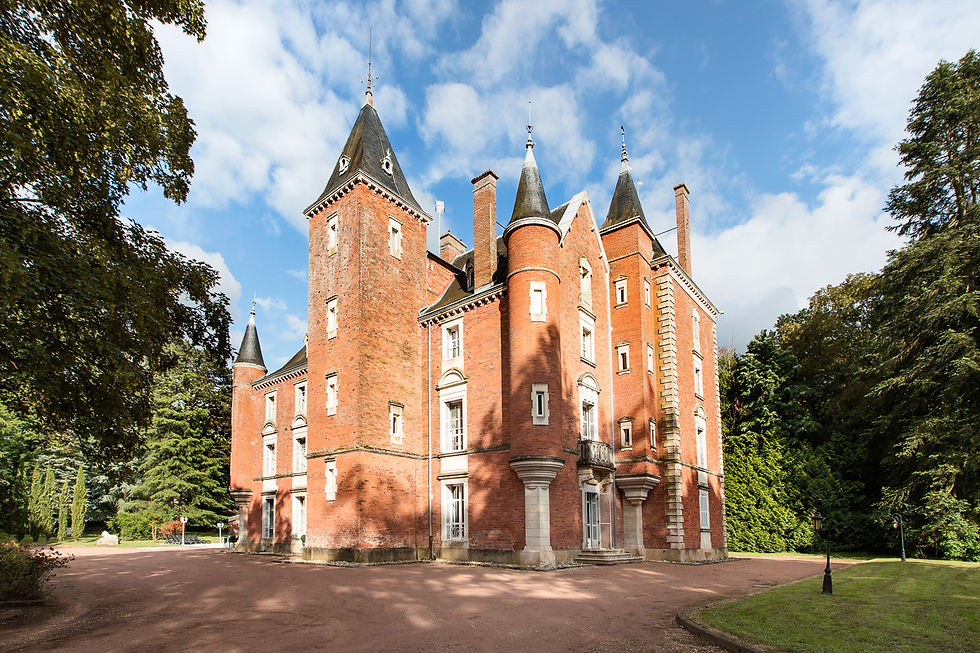 Red brick Château de Montsymond with pointed turrets.