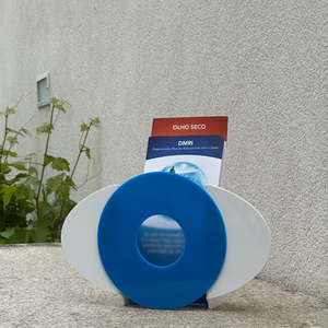 Final acrylic eye‑inspired flyer display model showing front view of abstract eye motif for product design portfolio.