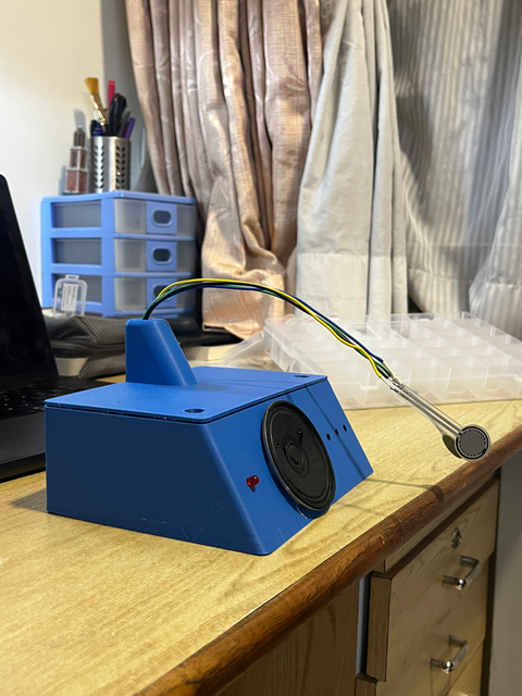 Blue enclosure prototype on a workbench, showing iterative fabrication, product prototyping, and workshop development work.