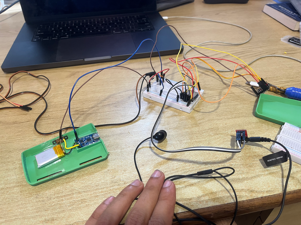 a person 's hand is touching a breadboard with wires connected to it