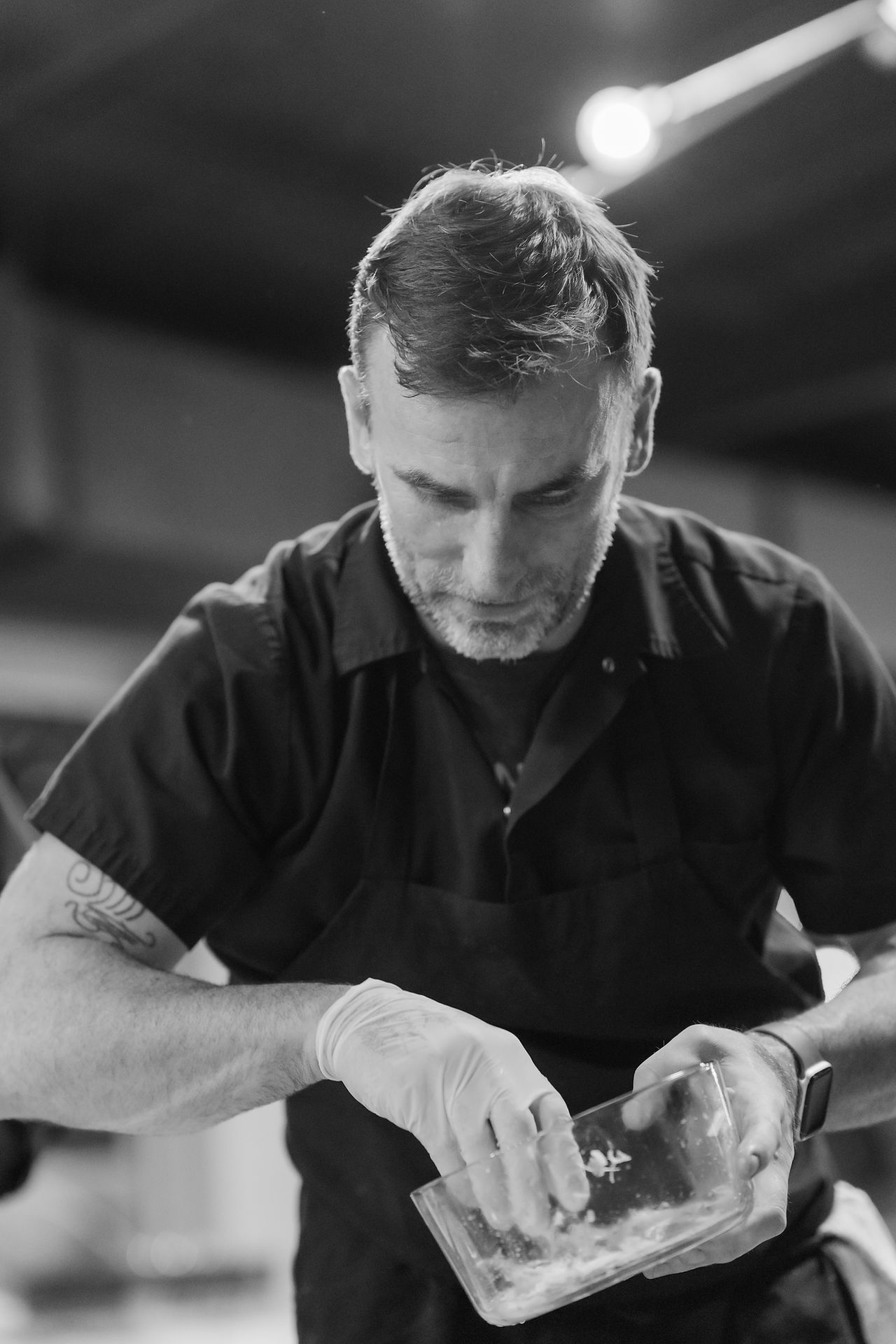black and white close up of chef sam diminich working