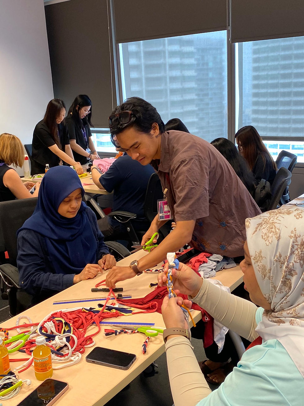 Kloth's upcycling workshop head trainer, Fitri, teaches participants how to make a braided coaster from old T-shirts.