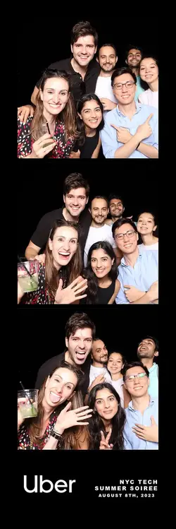 Uber NYC Tech Summer Soiree on August 8th, 2023, featuring a fun photo booth moment with smiling att