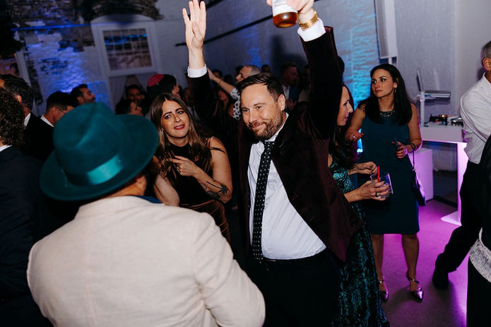 “Wedding guests dancing and celebrating during a lively reception with music by DJ Dan Fudim, a NY wedding DJ offering professional DJ services, including DJ services NYC, CT wedding DJ, and Hudson Valley wedding DJ entertainment.”