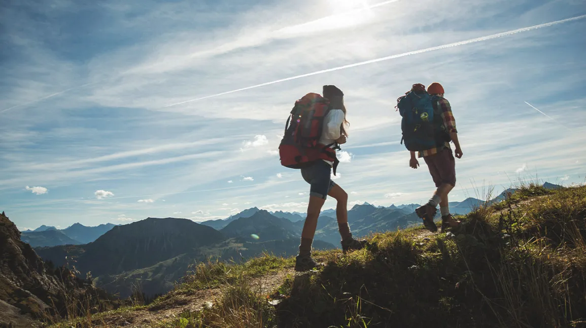 couple-hiking-mountain-climbing-1296x728-header.webp
