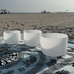 Crystal singing bowls for a Christian sound bath on a Long Island beach