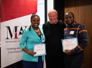 Seraphine and Erasmos hold their training certificates alongside facilitator Harry Miller